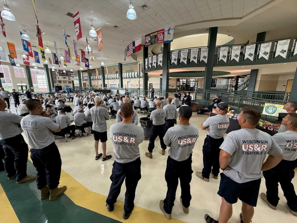 Members of Wisconsin Task Force 1 swiftwater team listens to operational briefing in Texas. Courtesy: Wisconsin Task Force 1