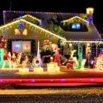 A house in winter absolutely covered in holiday lights