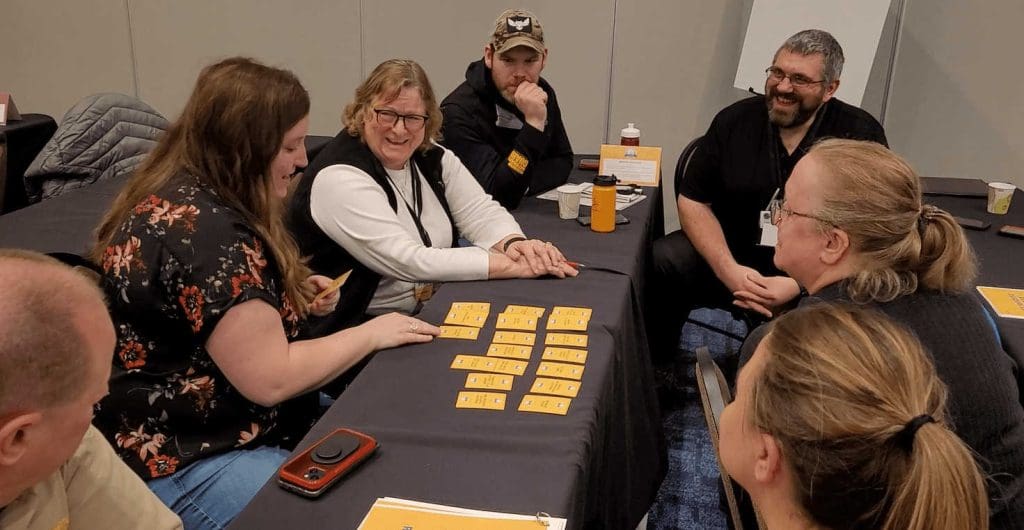 Conference attendees playing a card game and talking
