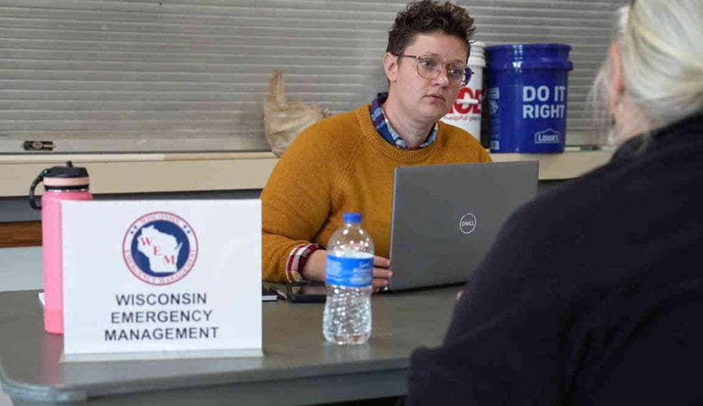 Talking to a flood survivor at the disaster recovery center