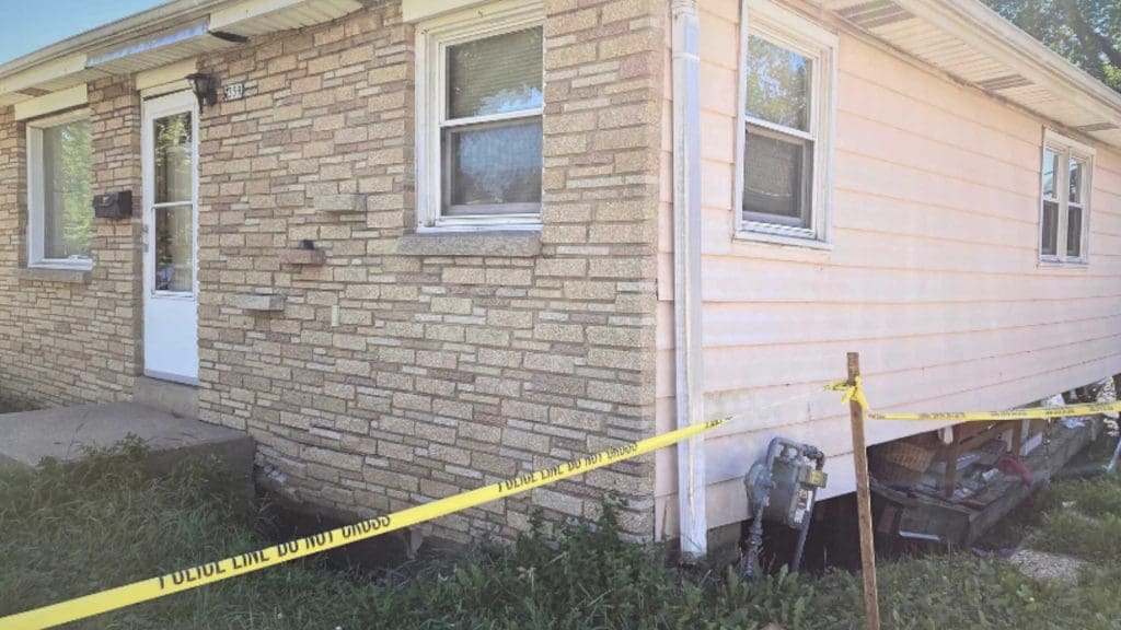 A house with a collapsed foundation due to flooding
