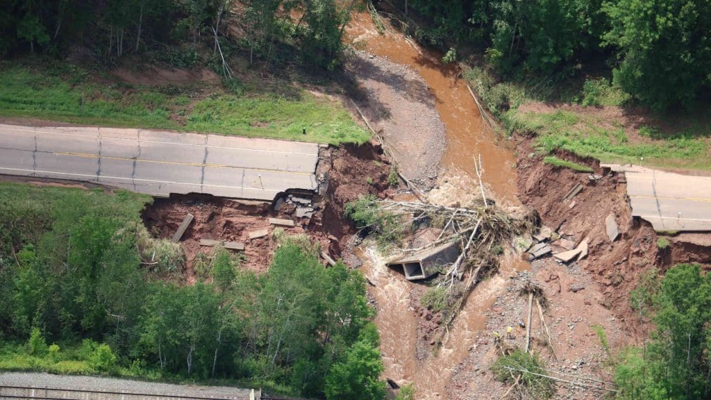 A washed out bridge and road after a flooding event