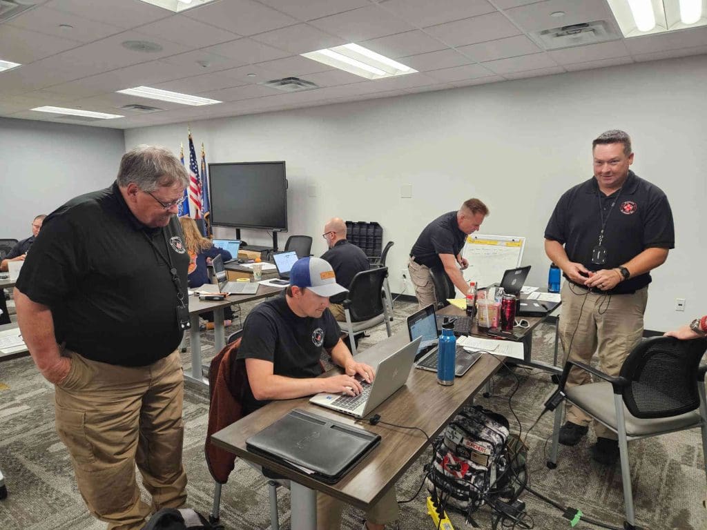 People at desks working together on laptops
