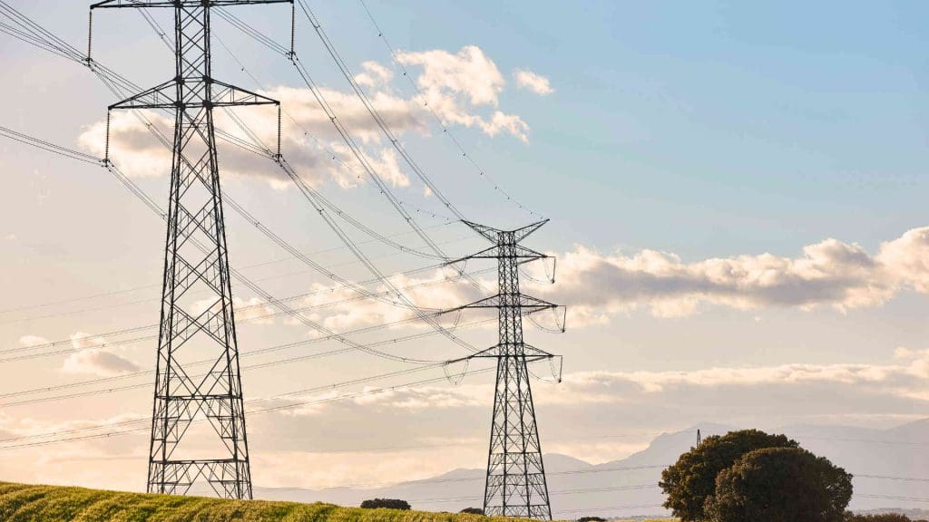 powerlines in front of a blue cloudy sky