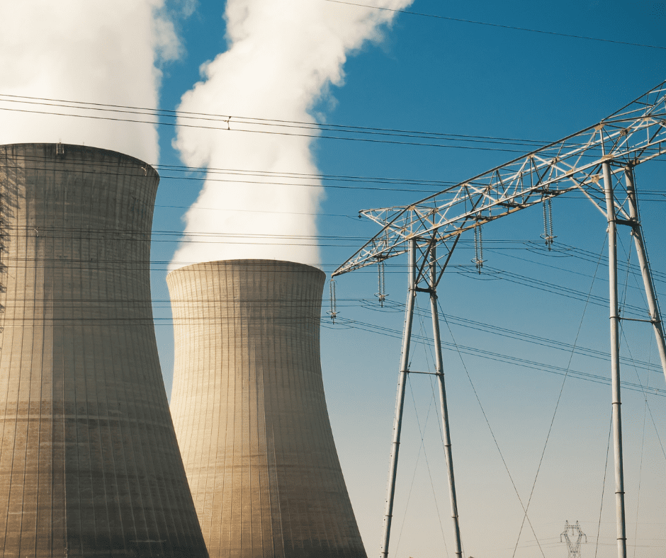 Nuclear power plant towers with steam rising off of them