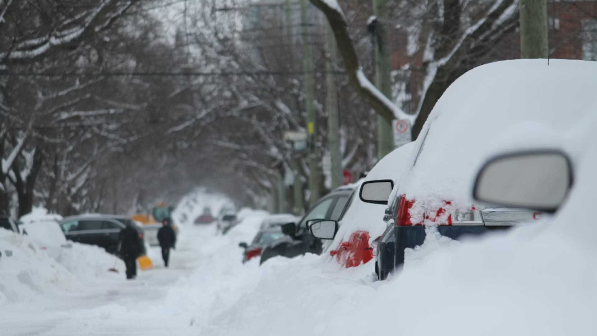 a street full of snow covered cars