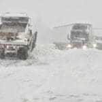 snow plows working and semi's stuck on a highway