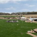 A shed in a pond after a tornado passed through a farm.
