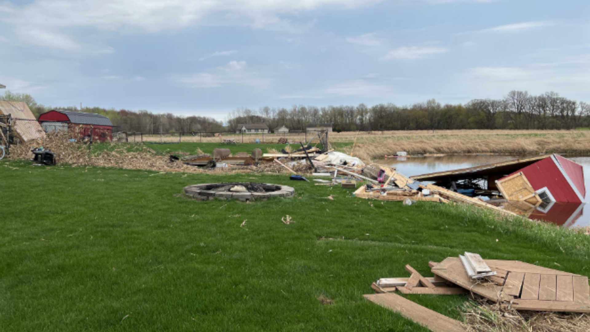 A shed in a pond after a tornado passed through a farm.