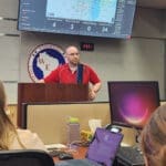 Someone giving a presentation on weather in the SEOC