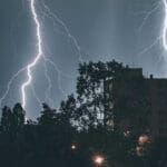 Lighting striking in a city at night