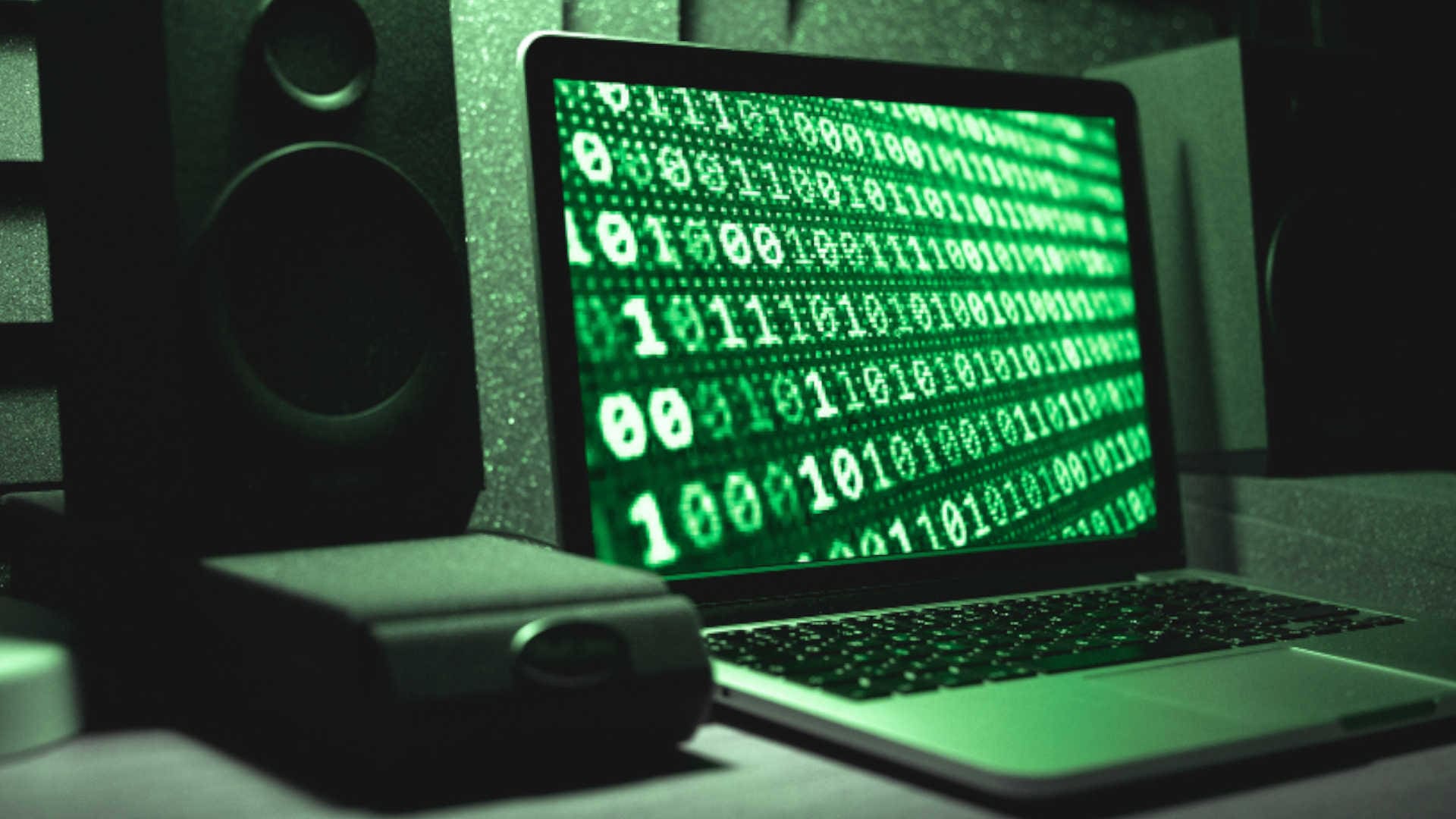 Laptop with a generic 1 and 0 wallpaper with a green tone