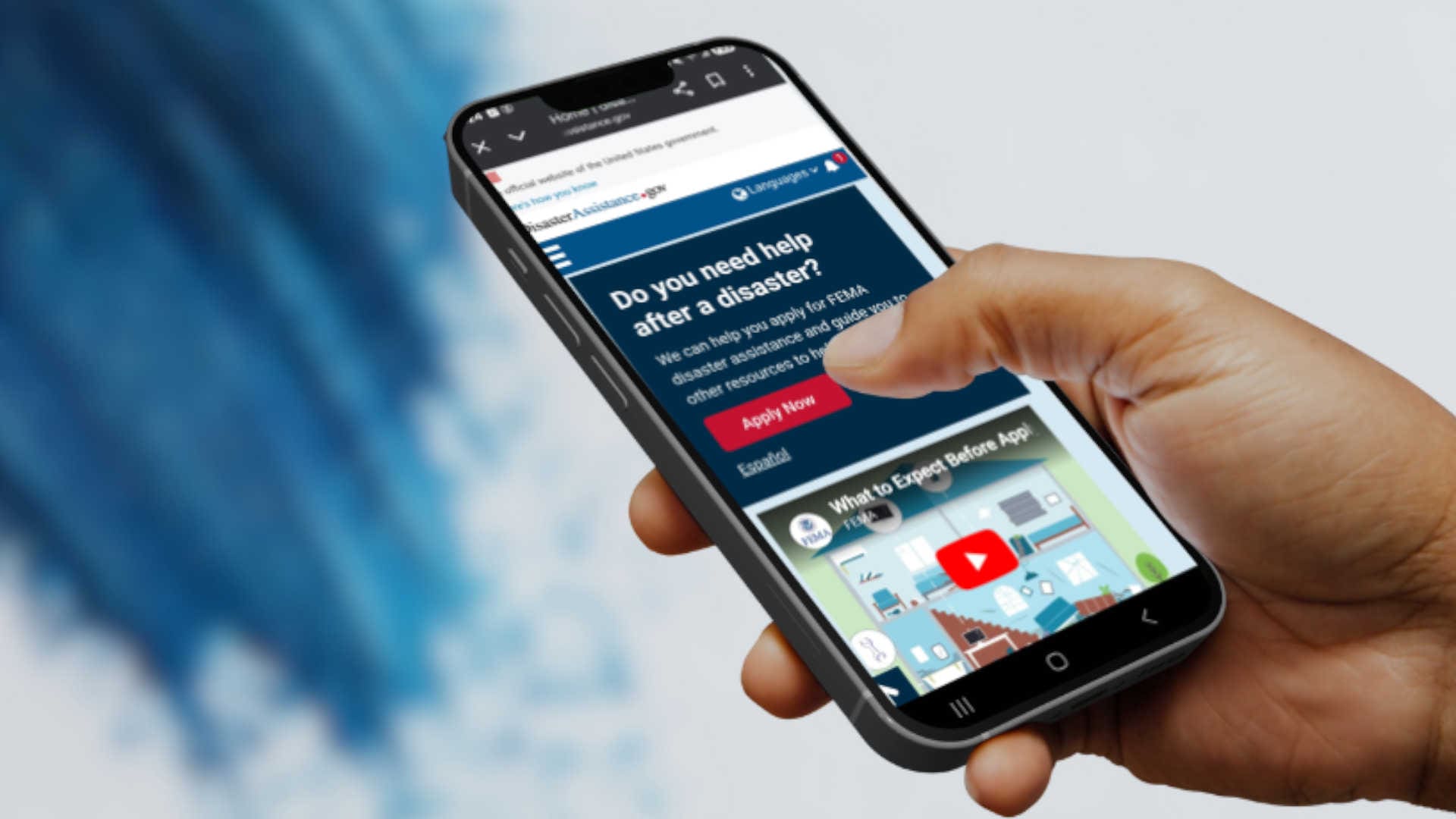 A phone with the disaster help FEMA page pulled up