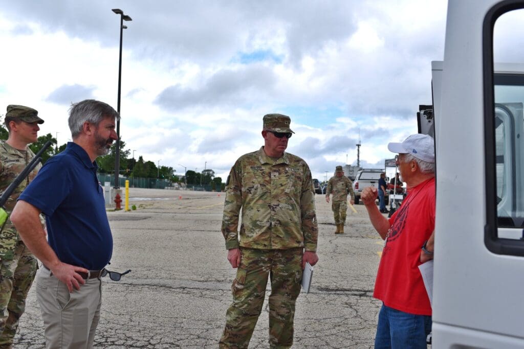 Brig. Gen. Matthew Beilfuss and WEM Administrator Greg Engle speak to an amateur radio participant in the 2024 SIMCOM exercise. Photo by: WI DMA Staff.