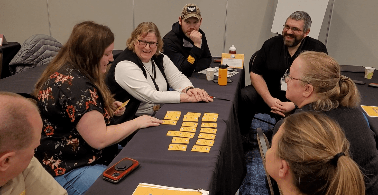 attendees playing a card game and talking