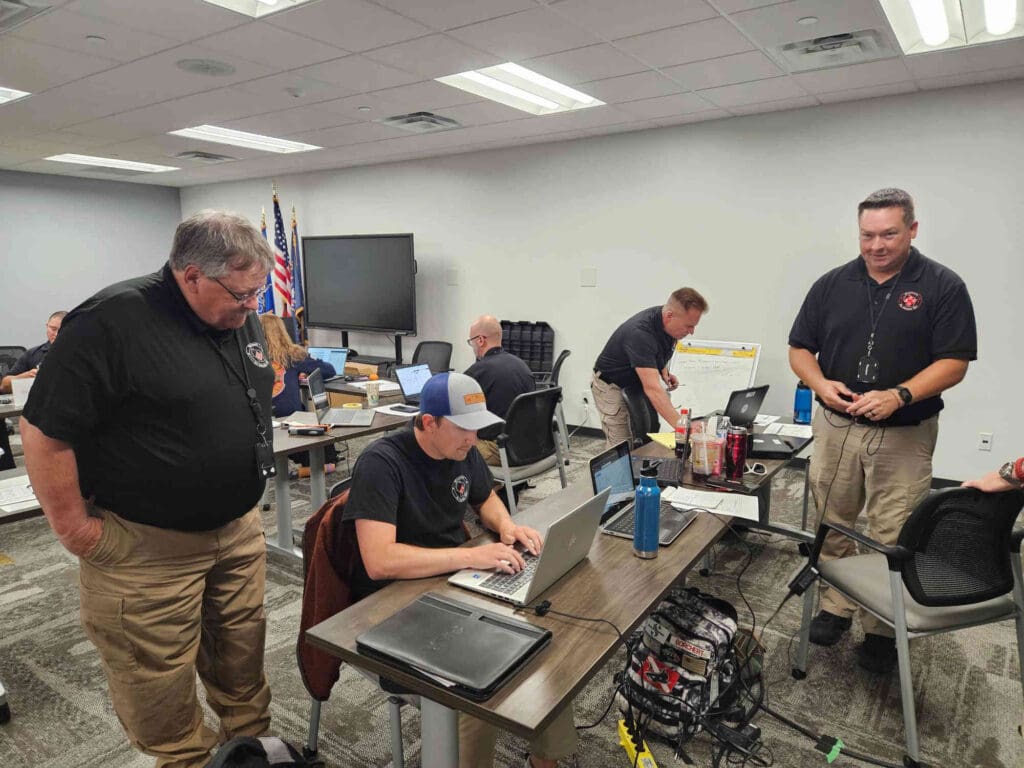 People at desks working together on laptops