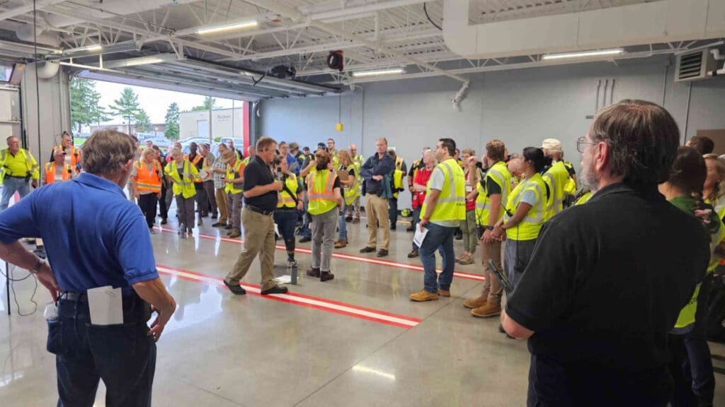 A group of safety crews getting ready in a large room