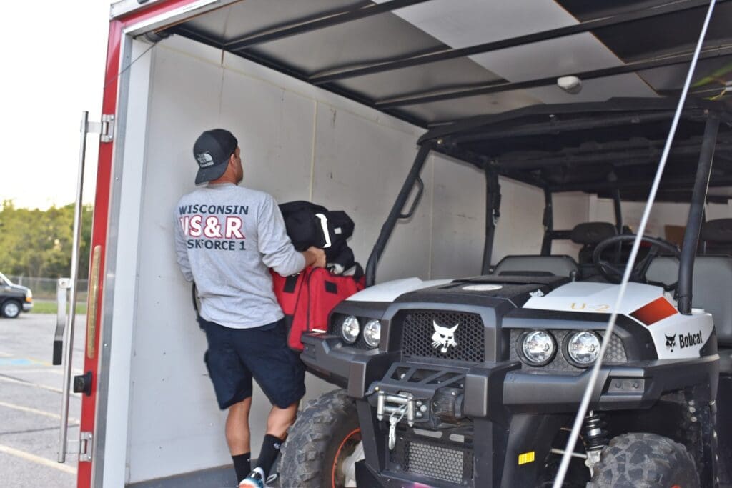 WI-TF1 members load a trailer at The REACT Center before departure.